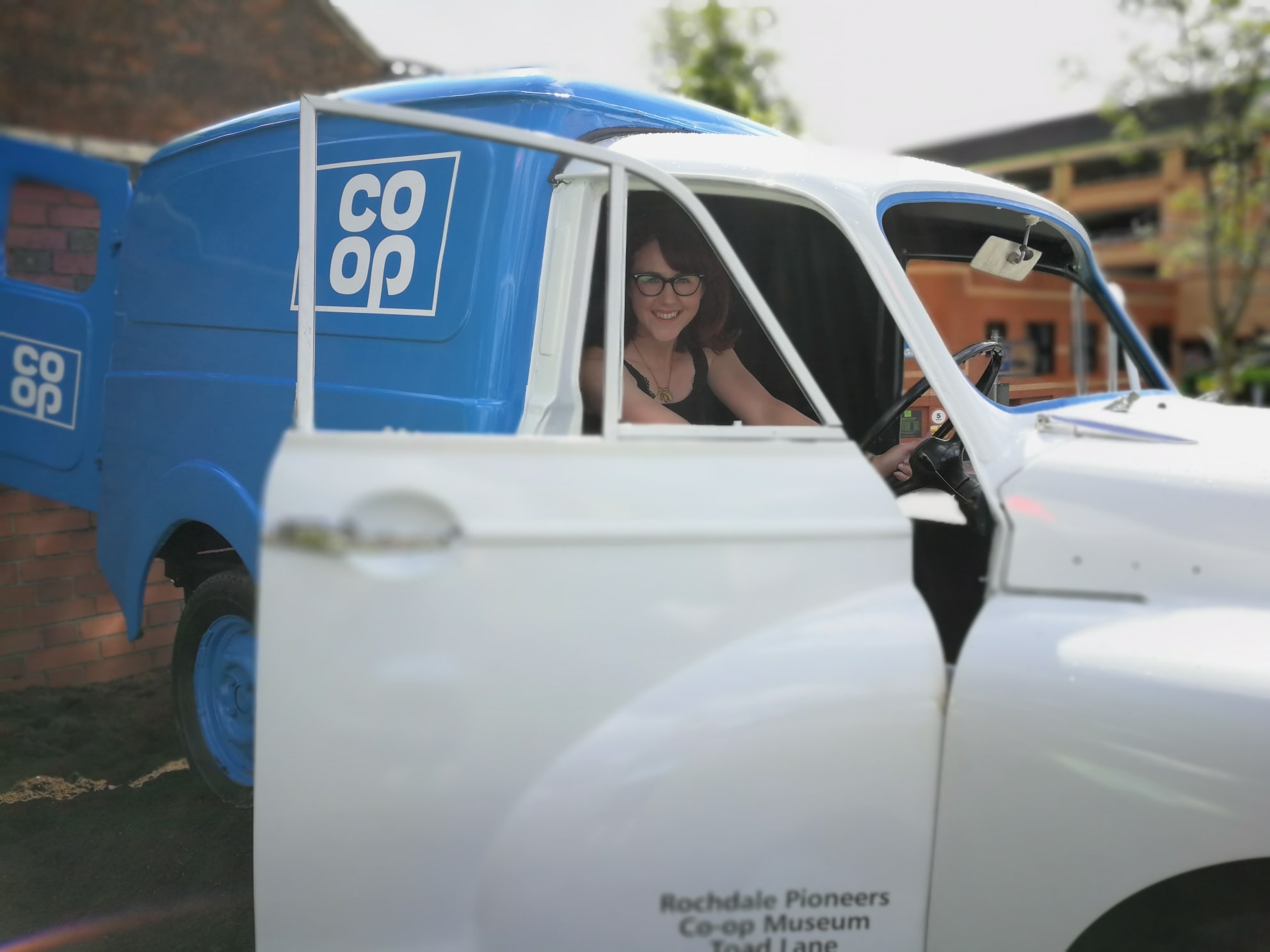 female sitting in a 1970s co-op delivery van